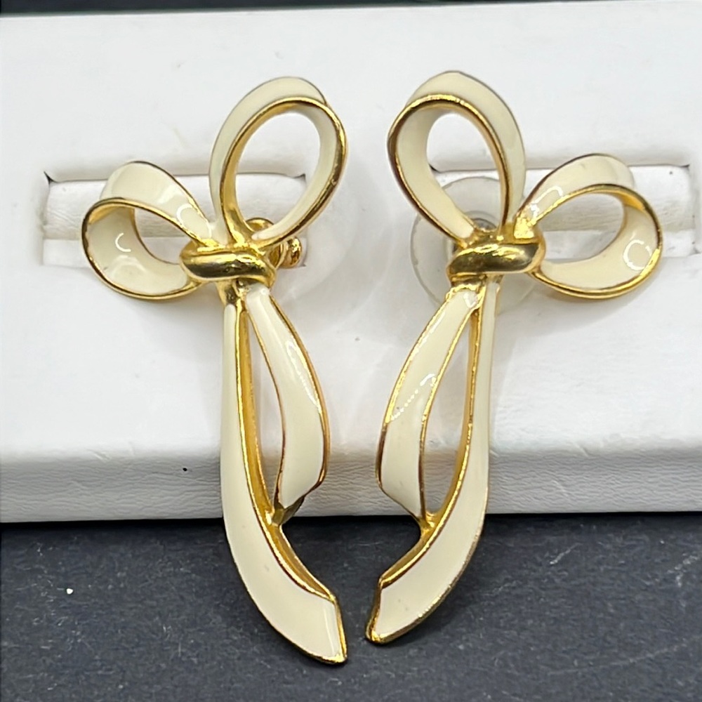 White enamel gold trim bow earrings